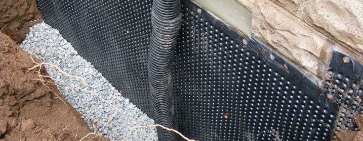 Another view of fresh foundation waterproofing in trench of residential home