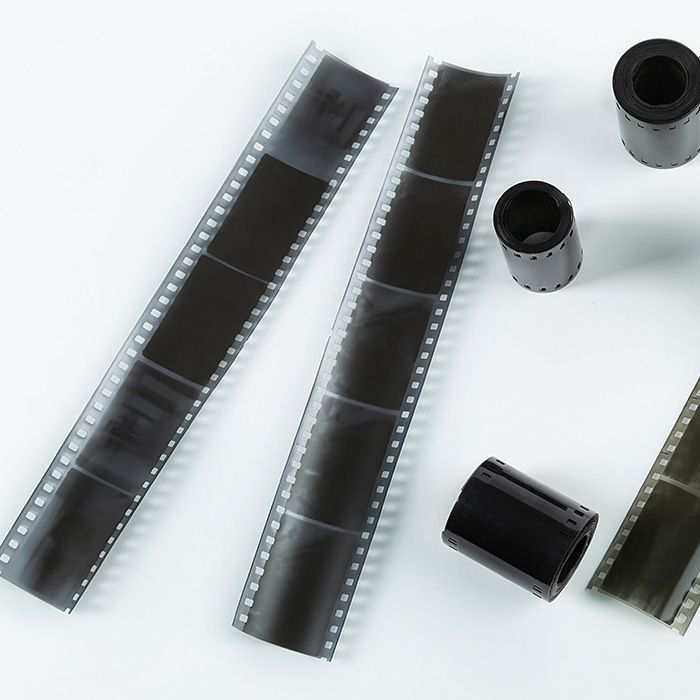 Several rolls of film are laying on a white surface
