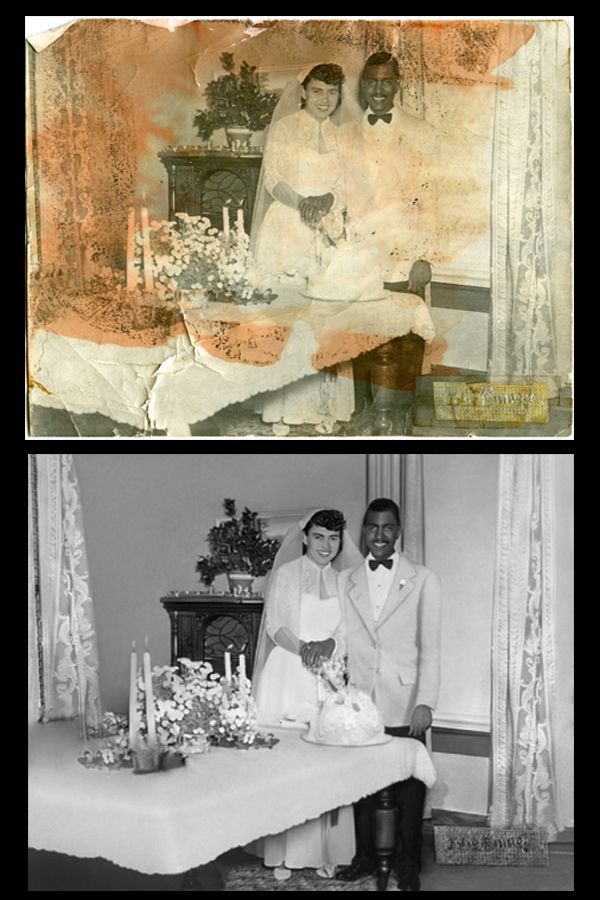 A black and white photo of a bride and groom cutting their wedding cake
