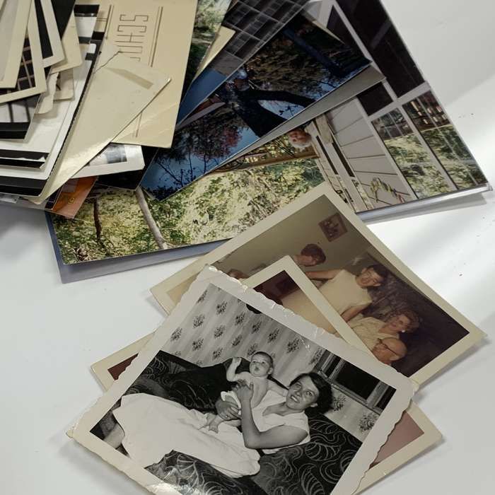 A pile of old photographs with one that says ' sophie ' on it