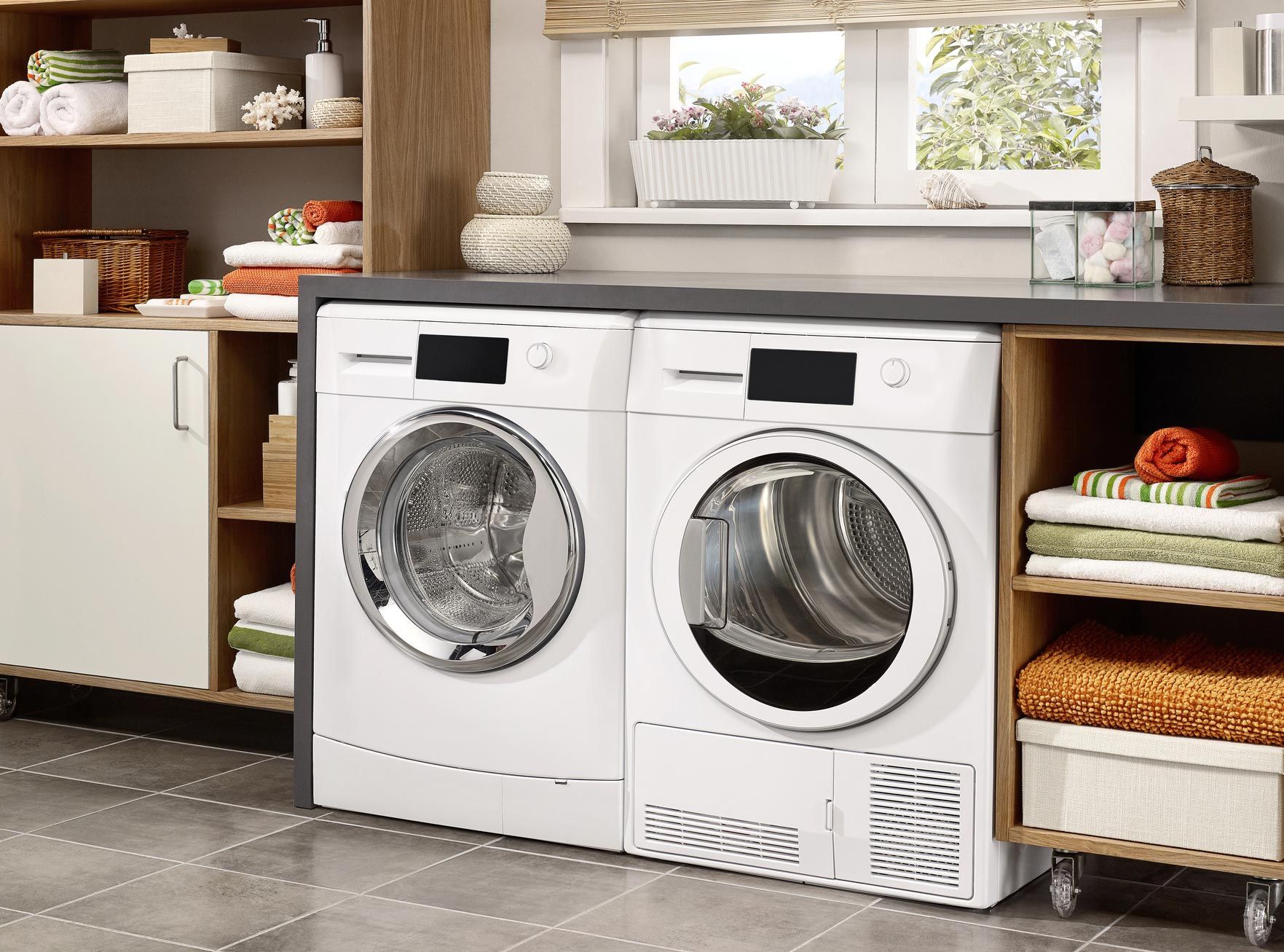 A laundry room with a washer and dryer on a counter.