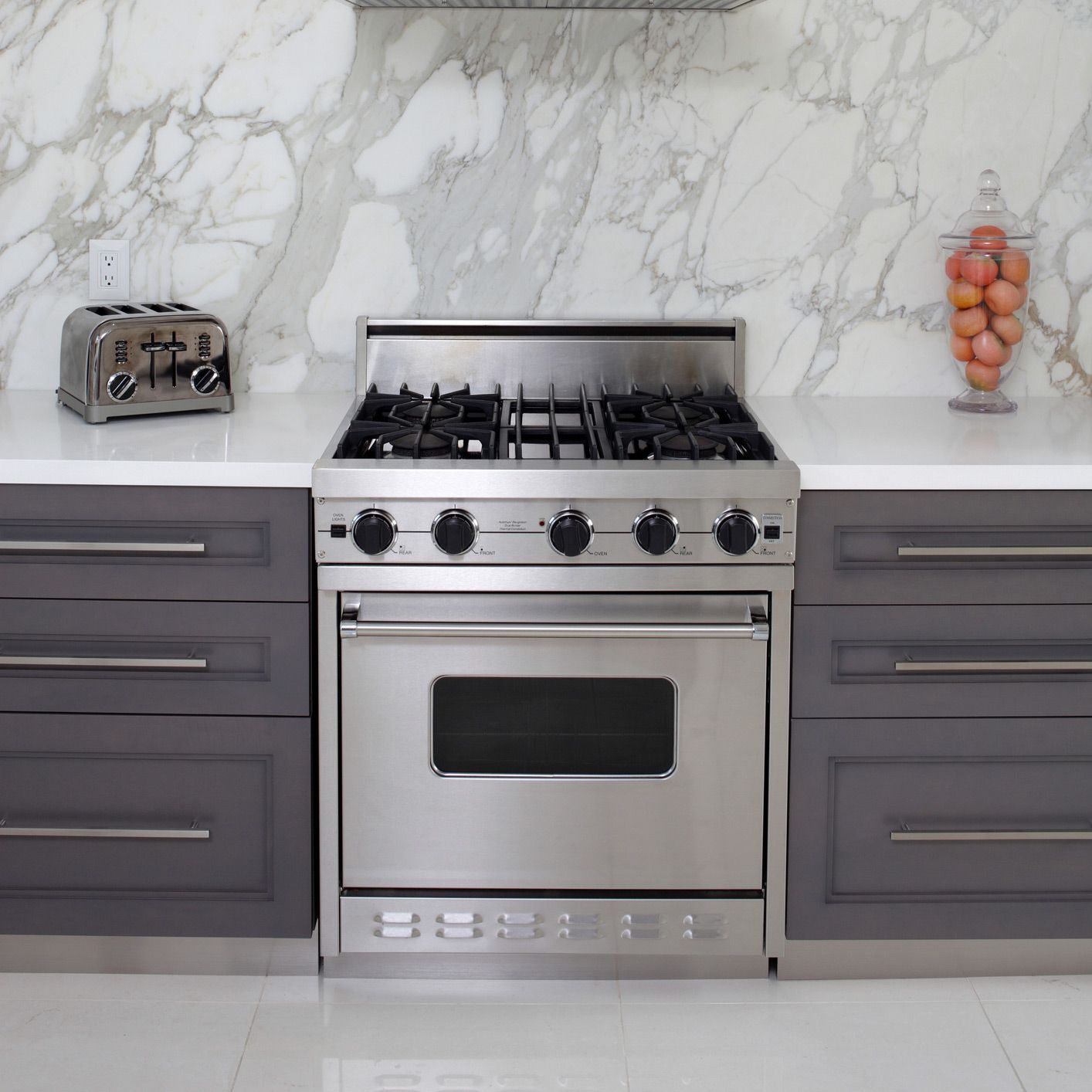 A kitchen with a stove top oven and a toaster