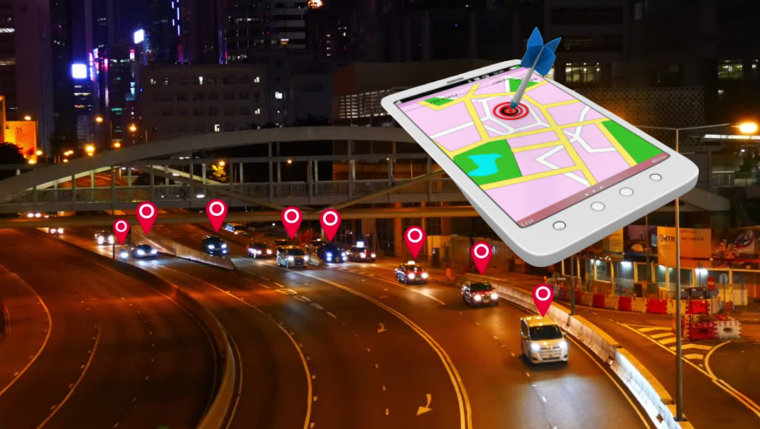 A cell phone is sitting on top of a highway at night.