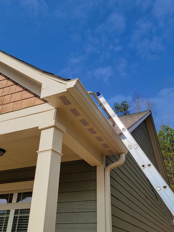 A ladder is attached to the side of a house.