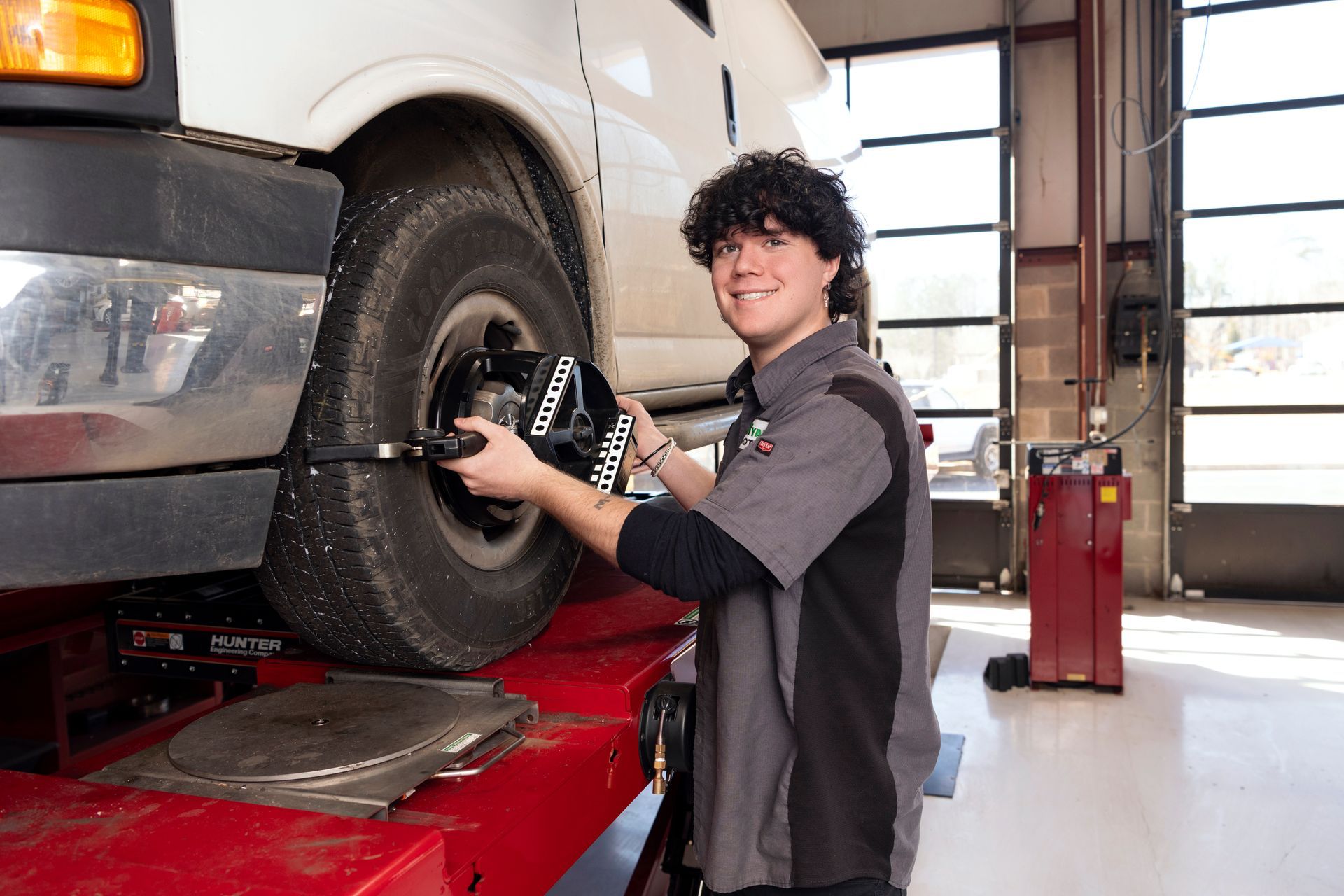 Mechanic changing a car tire in an auto repair shop