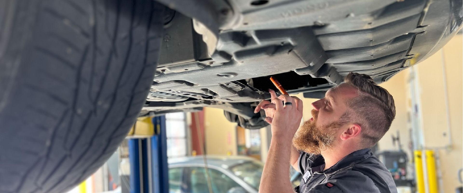 Team Ryan Automotive technician inspecting steering and suspension