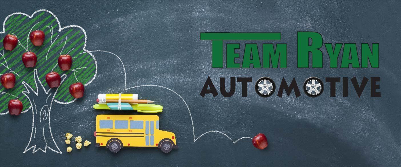a banner for Team Ryan Automotive  shows a school bus and an apple tree
