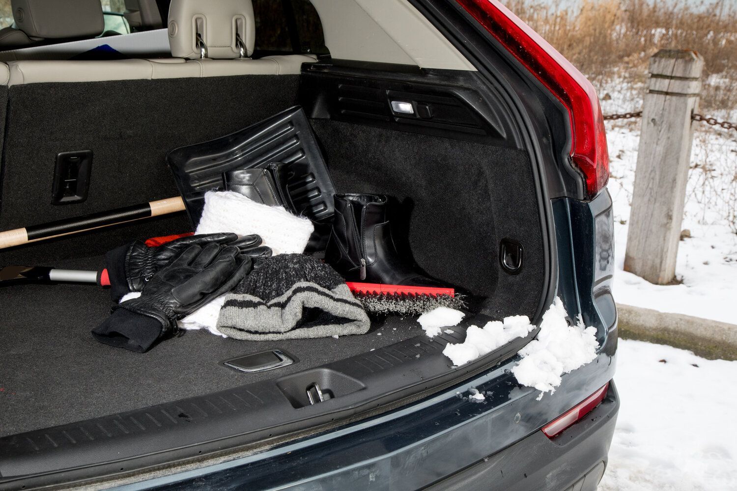 the trunk of a car is filled with snow and clothes