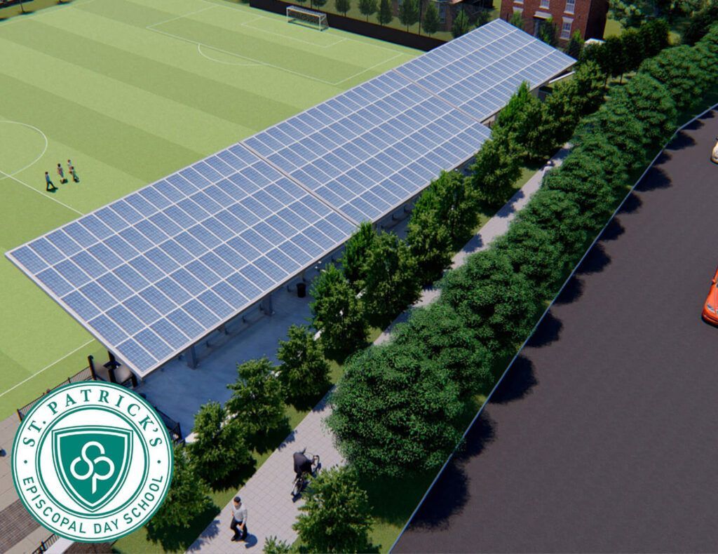 Covered walkway with solar-panel roof beside a tree-lined road and sports field