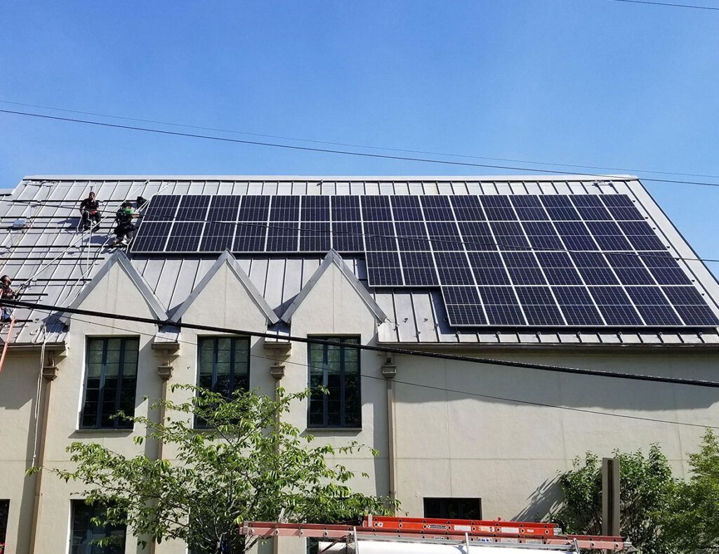 House roof covered with solar panels under a clear blue sky