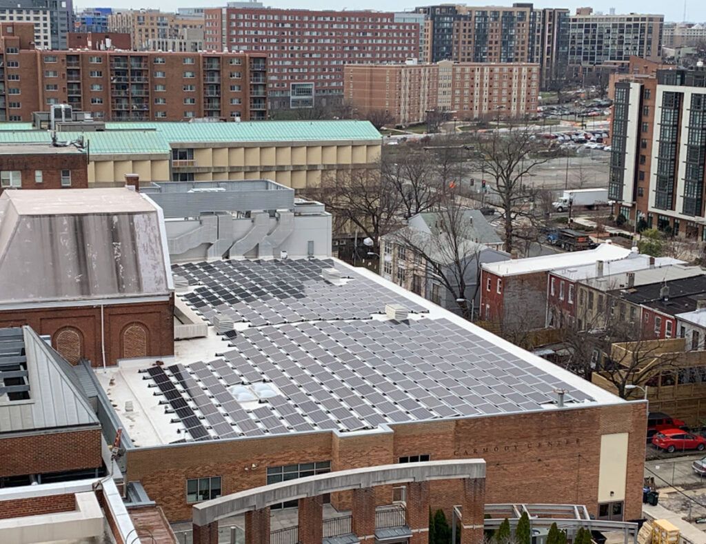 City skyline with brick buildings and snow-covered rooftops under a gray sky