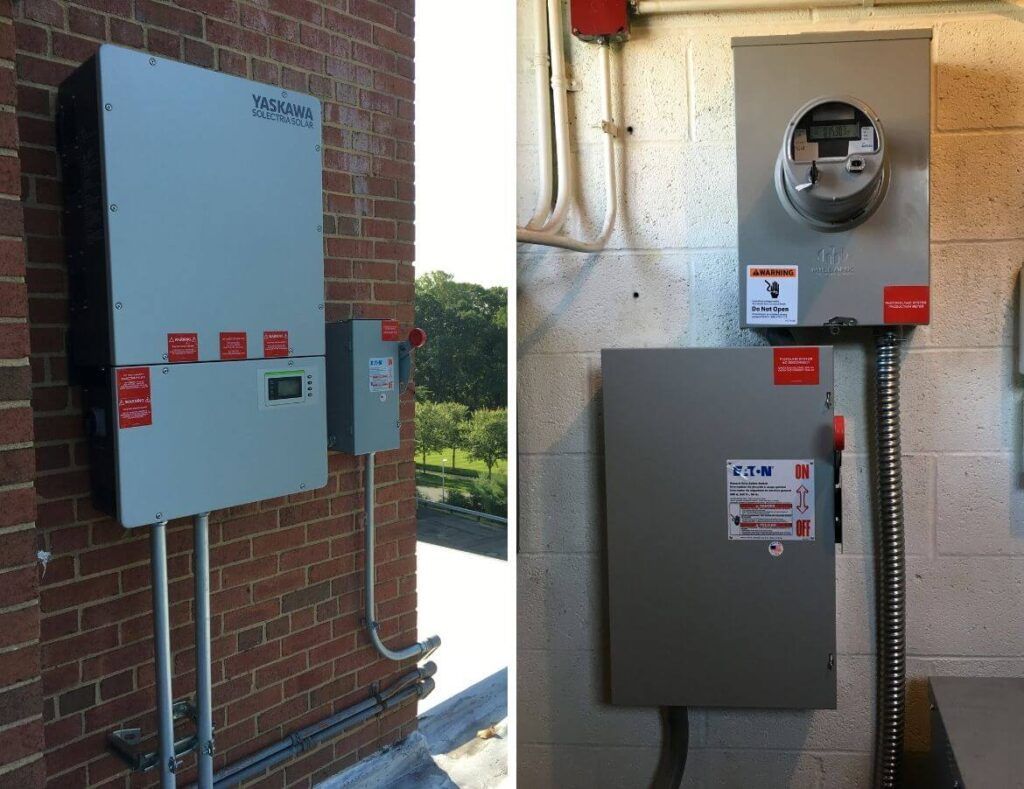 Two gray electrical panels mounted on brick and stucco exterior walls, with conduit and utility labels.