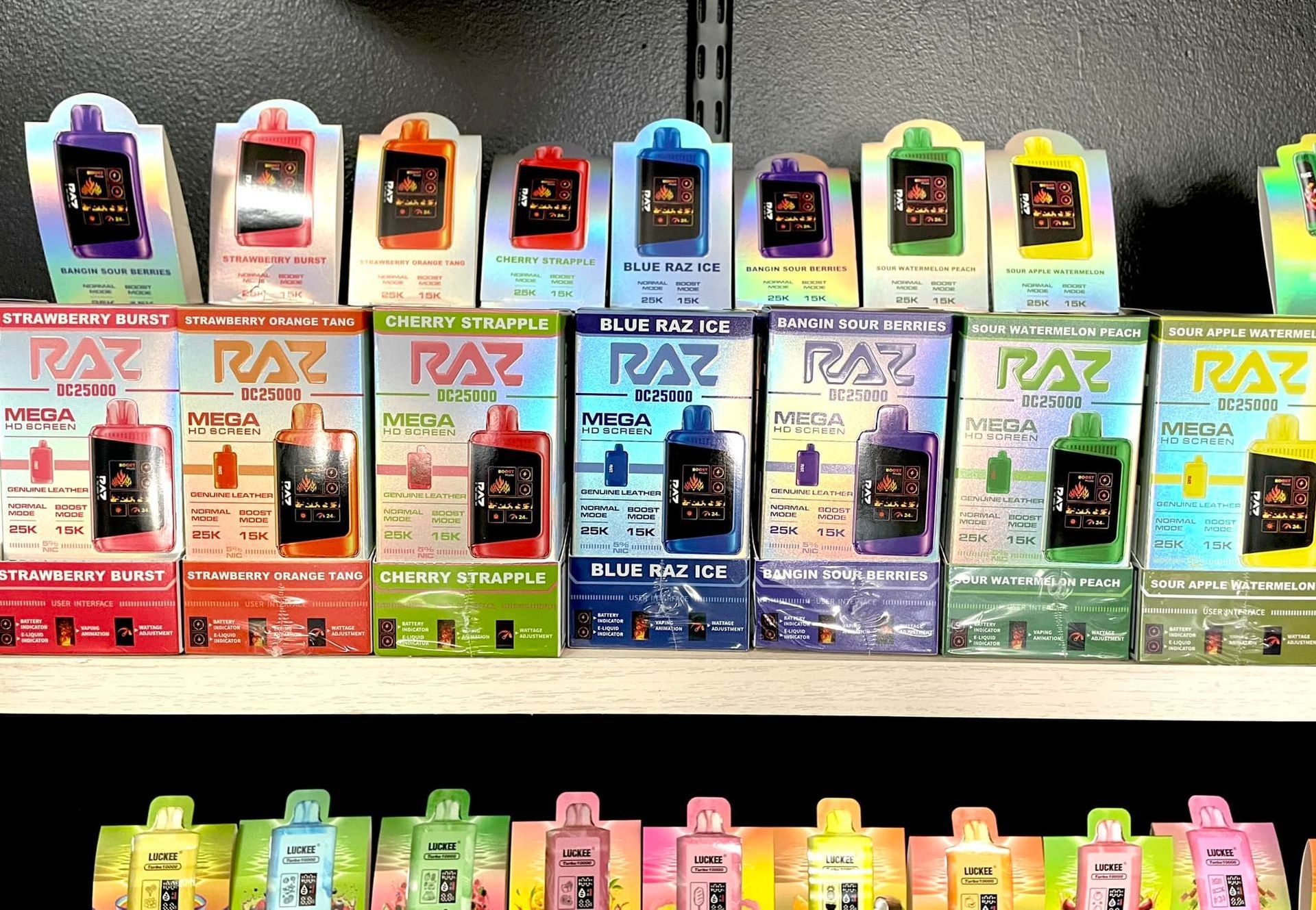 A shelf filled with boxes of raz e liquid.
