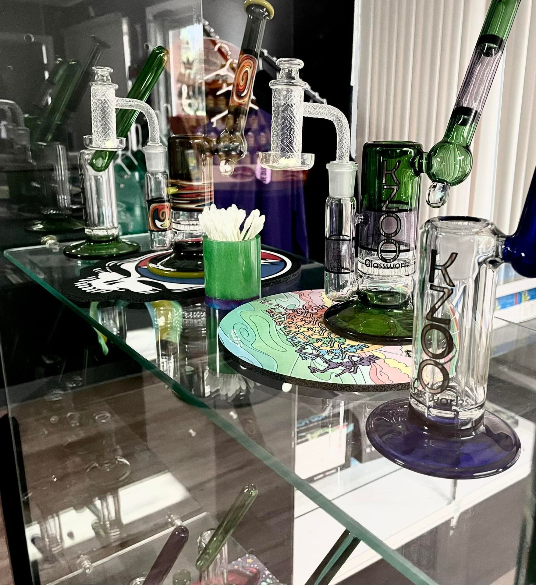 A glass display case filled with a variety of glass pipes.