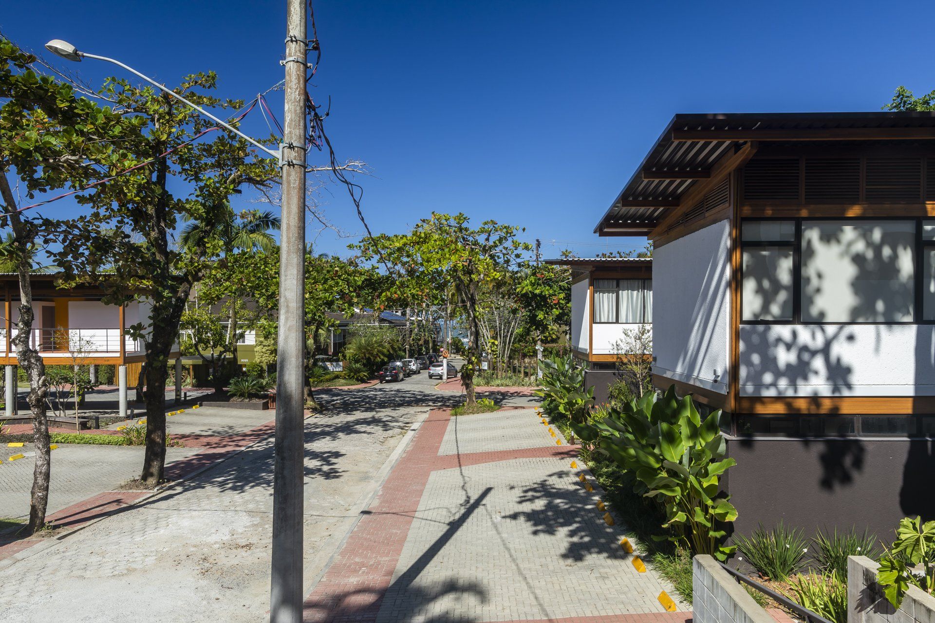 Uma fileira de casas está alinhada uma ao lado da outra em um dia ensolarado.