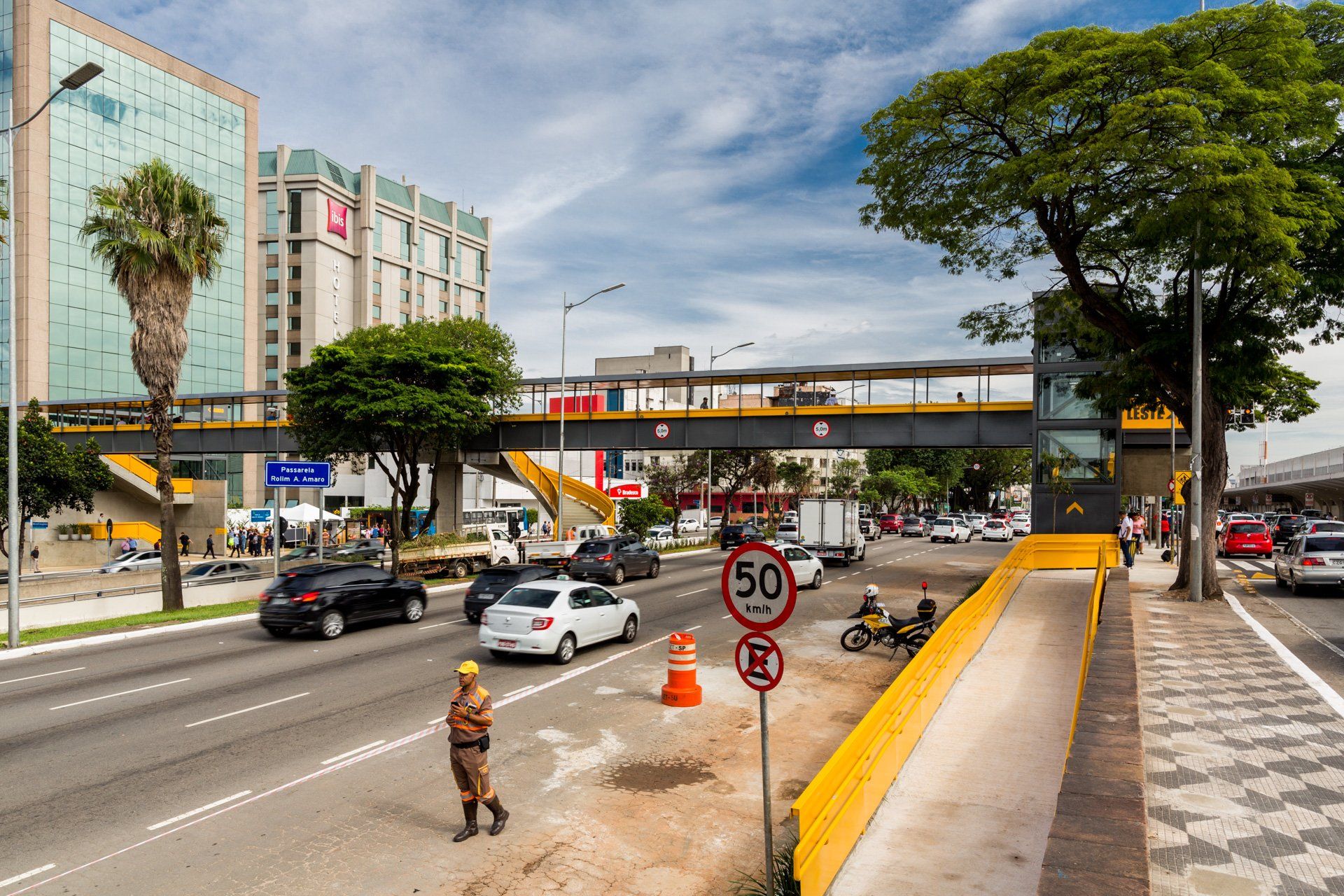 Um homem está parado no meio de uma rua movimentada.