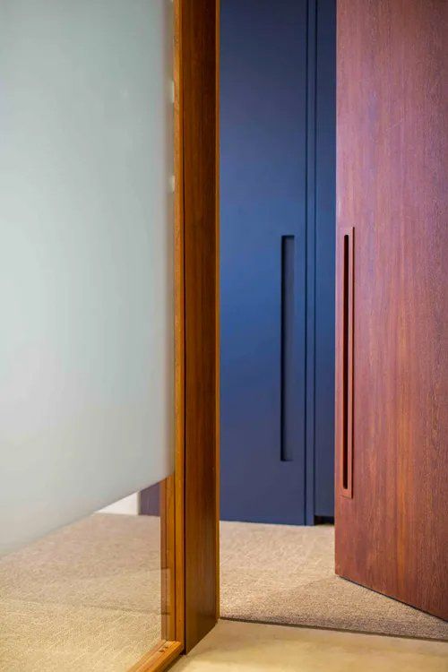 Um quarto com uma porta de madeira e uma porta azul