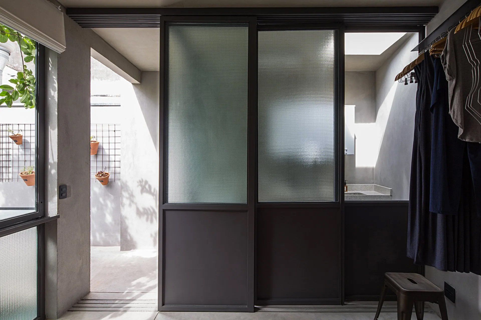 Uma sala com porta de vidro deslizante e banco