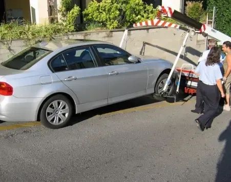 A Tow Truck is Towing a Car on a Highway — Kenny's Towing in Jensen, QLD