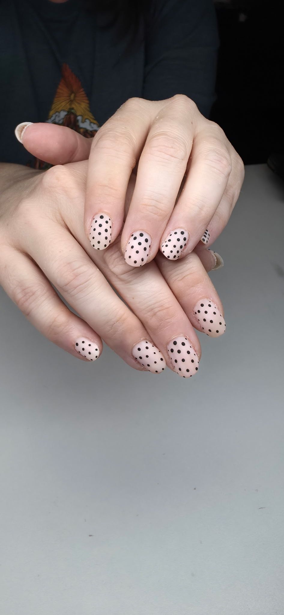 Close-up of hand with glossy pale pink manicured nails