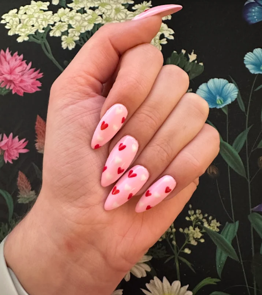 Close-up of hand with glossy pale pink manicured nails