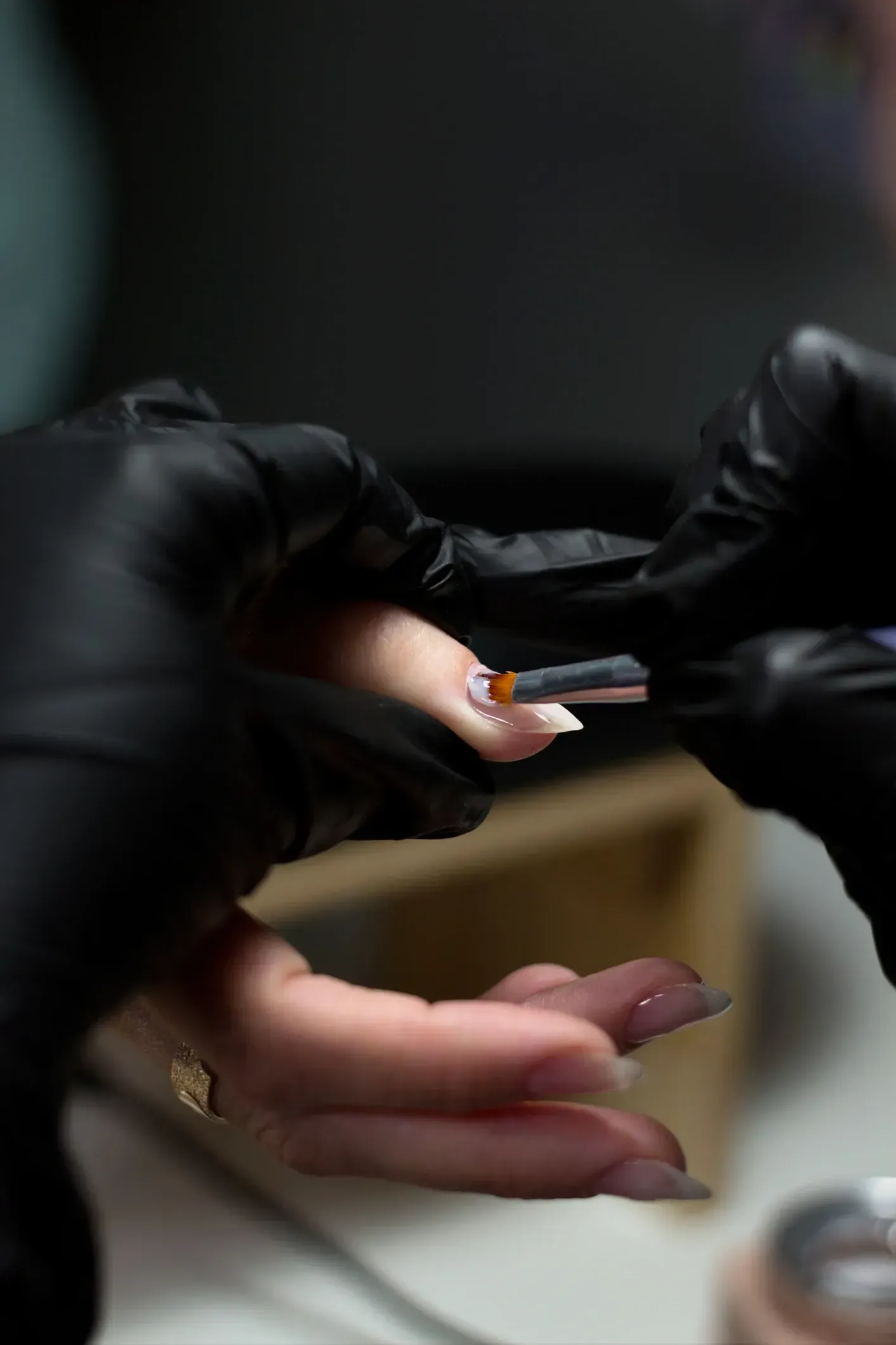 A woman wearing a t-mobile shirt has a ring on her finger