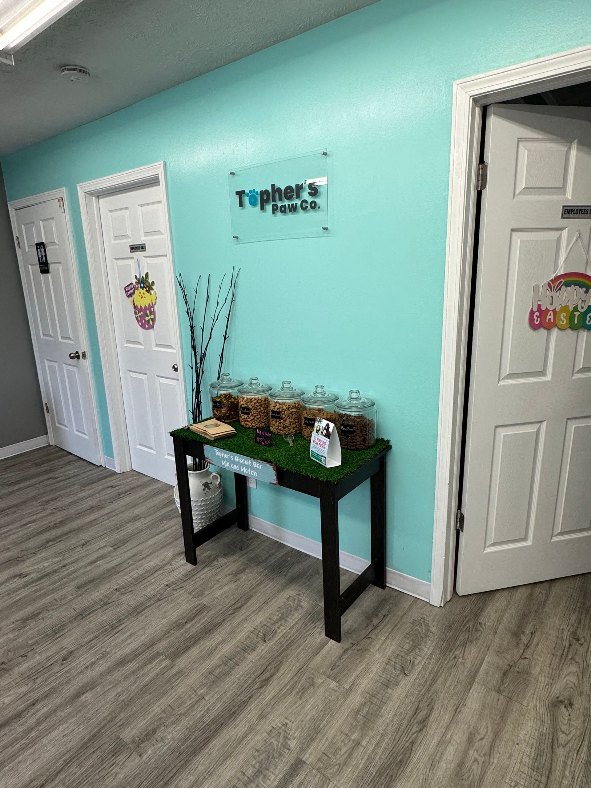 A hallway with a table and a sign on the wall.