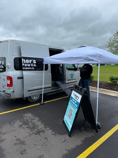 A her 's paw co. van is parked in a parking lot