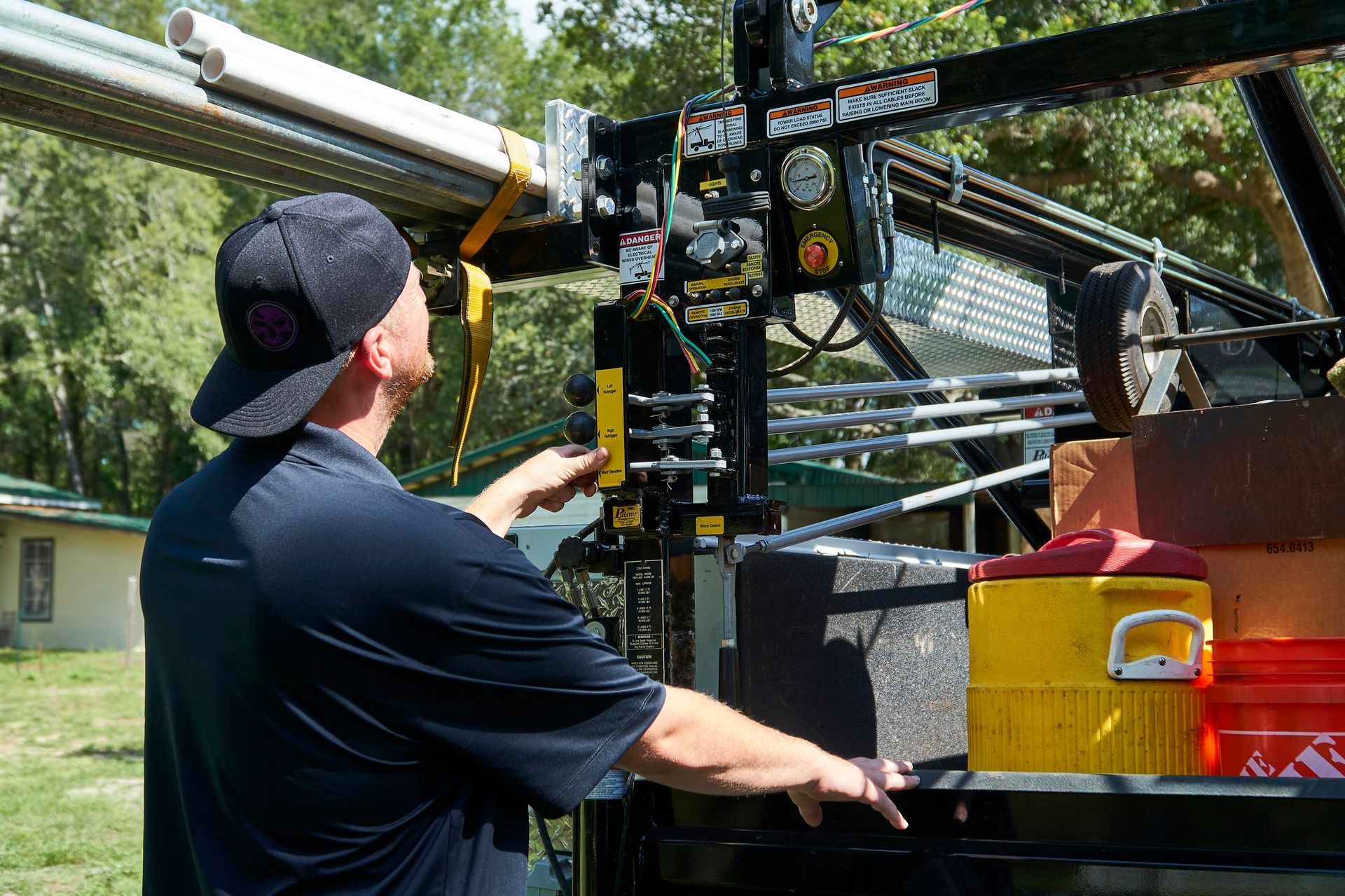 A man is working on a machine in the back of a truck.