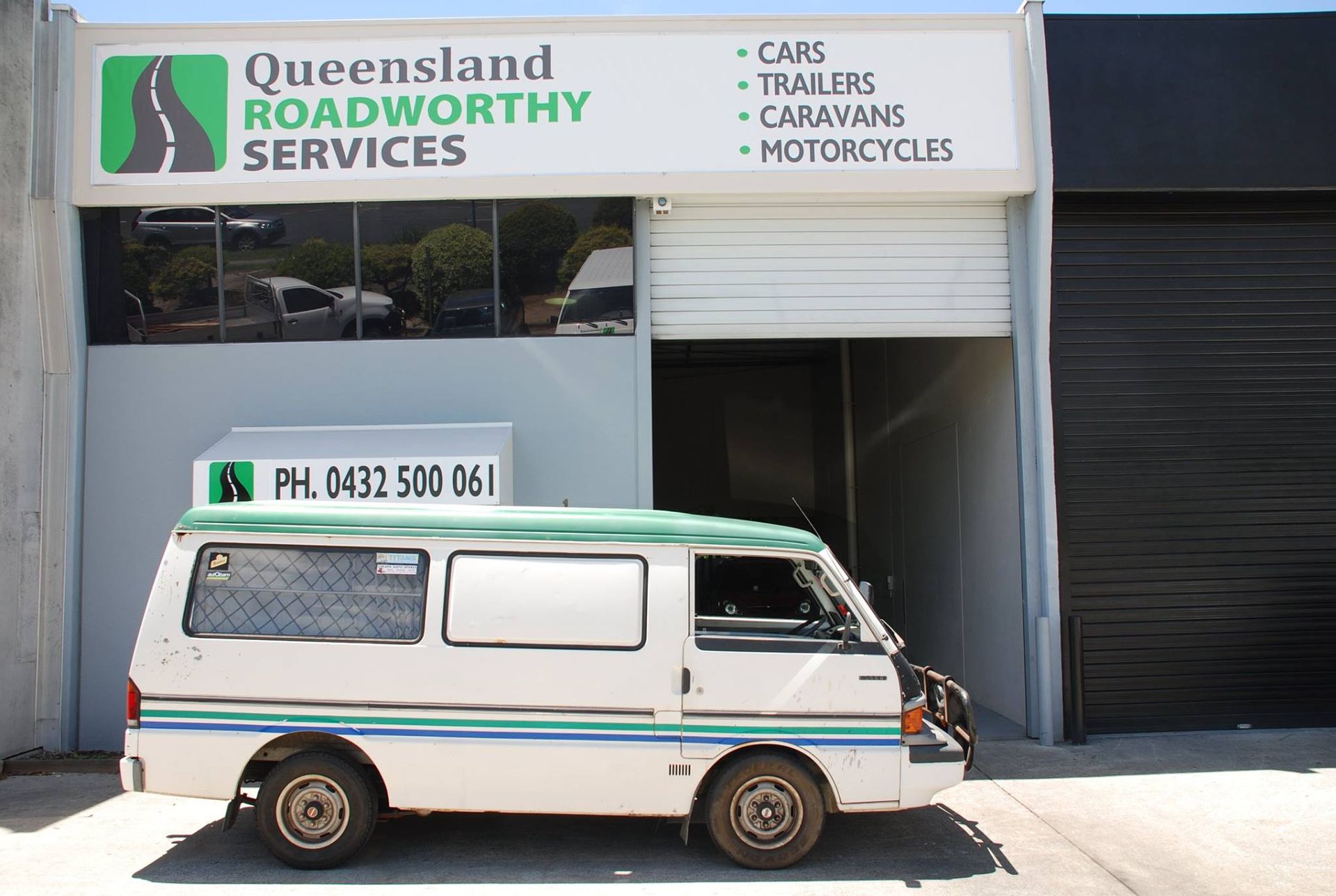 A white van is parked in front of queensland roadworthy services — Queensland Roadworthy Services In Southport, QLD