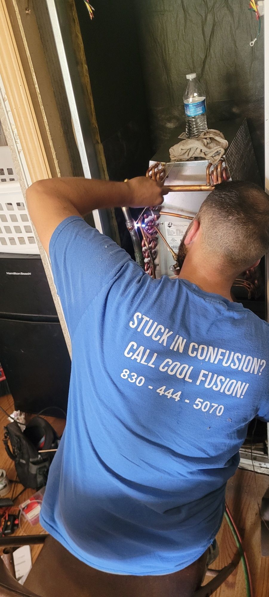 A person in a blue shirt with the text 
