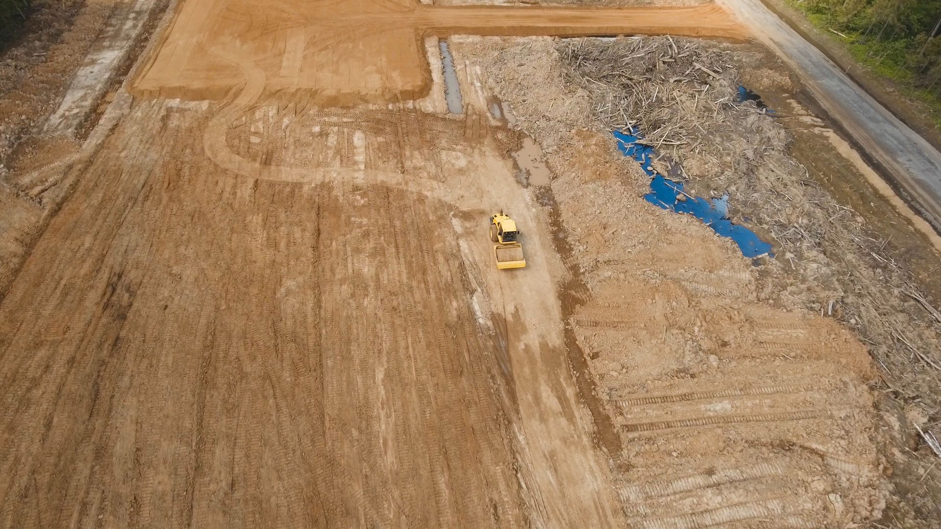 An aerial view of a construction site with a bulldozer leveling dirt.