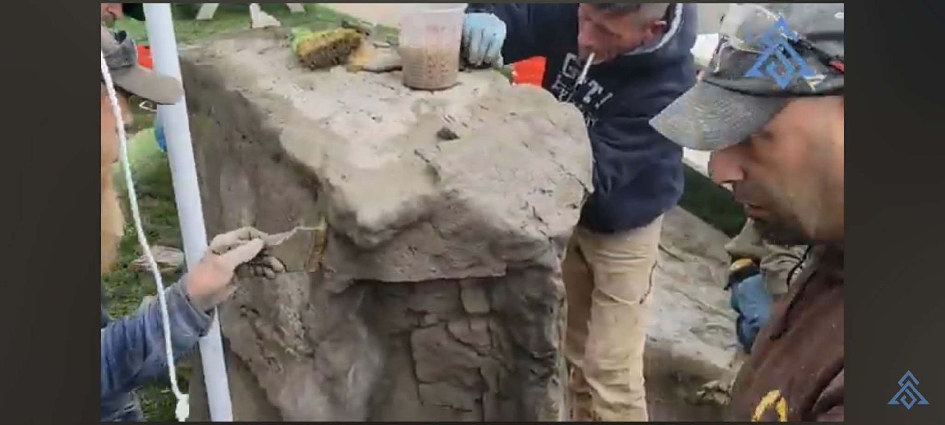 People inspecting a large cracked concrete structure outdoors with measuring tools and gloves