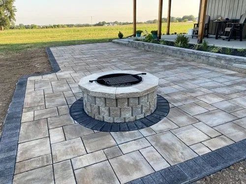 There is a fire pit in the middle of the patio.