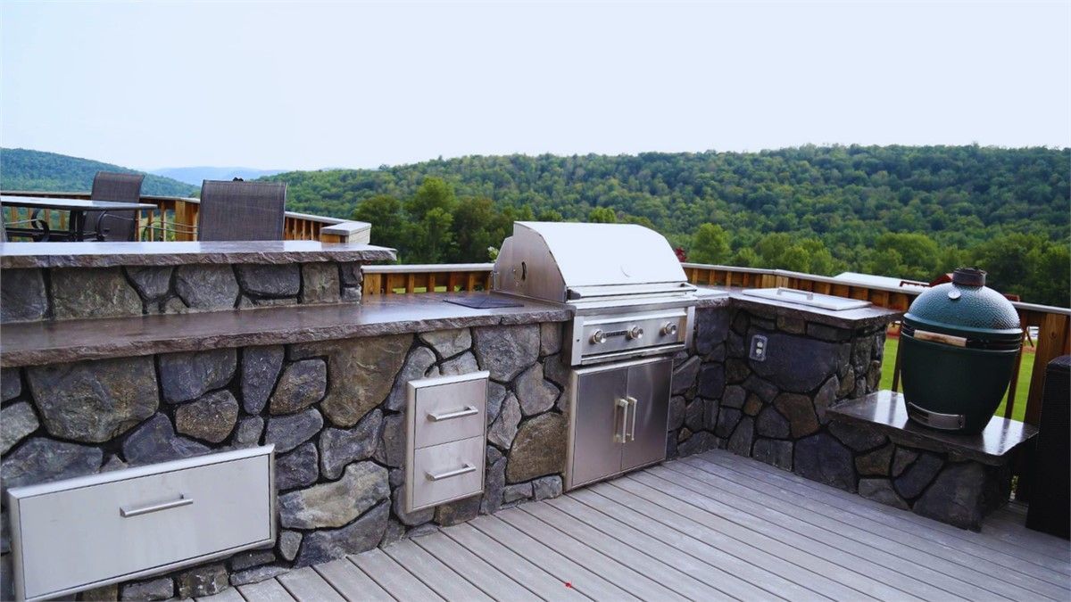 Outdoor Kitchen FAQ for KC: 10 Questions Answered. There is a grill on the roof of a house with a view of the mountains.