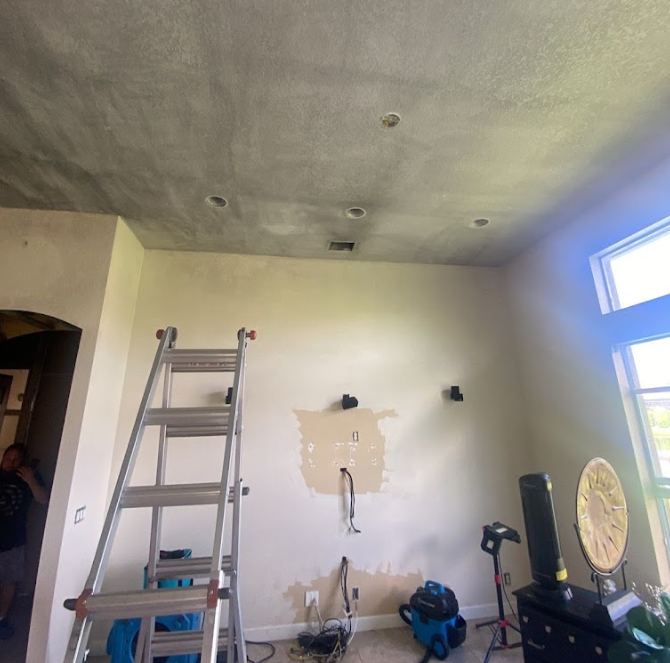 A room with a ladder and a clock on the wall