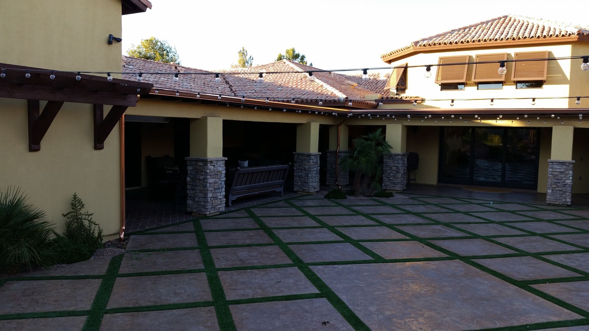 Technician installing a new seamless gutter section on a Phoenix East Valley home.
