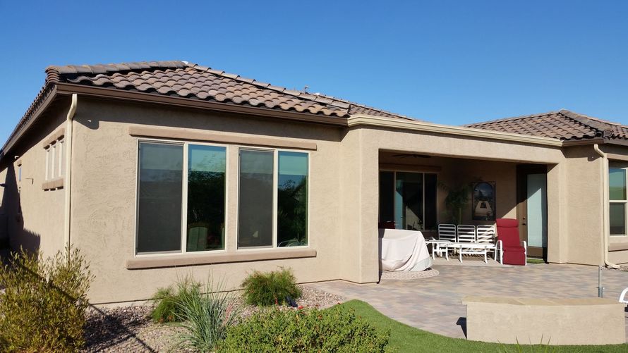 Commercial flat-roof scupper box and downspout system on an East Valley property.