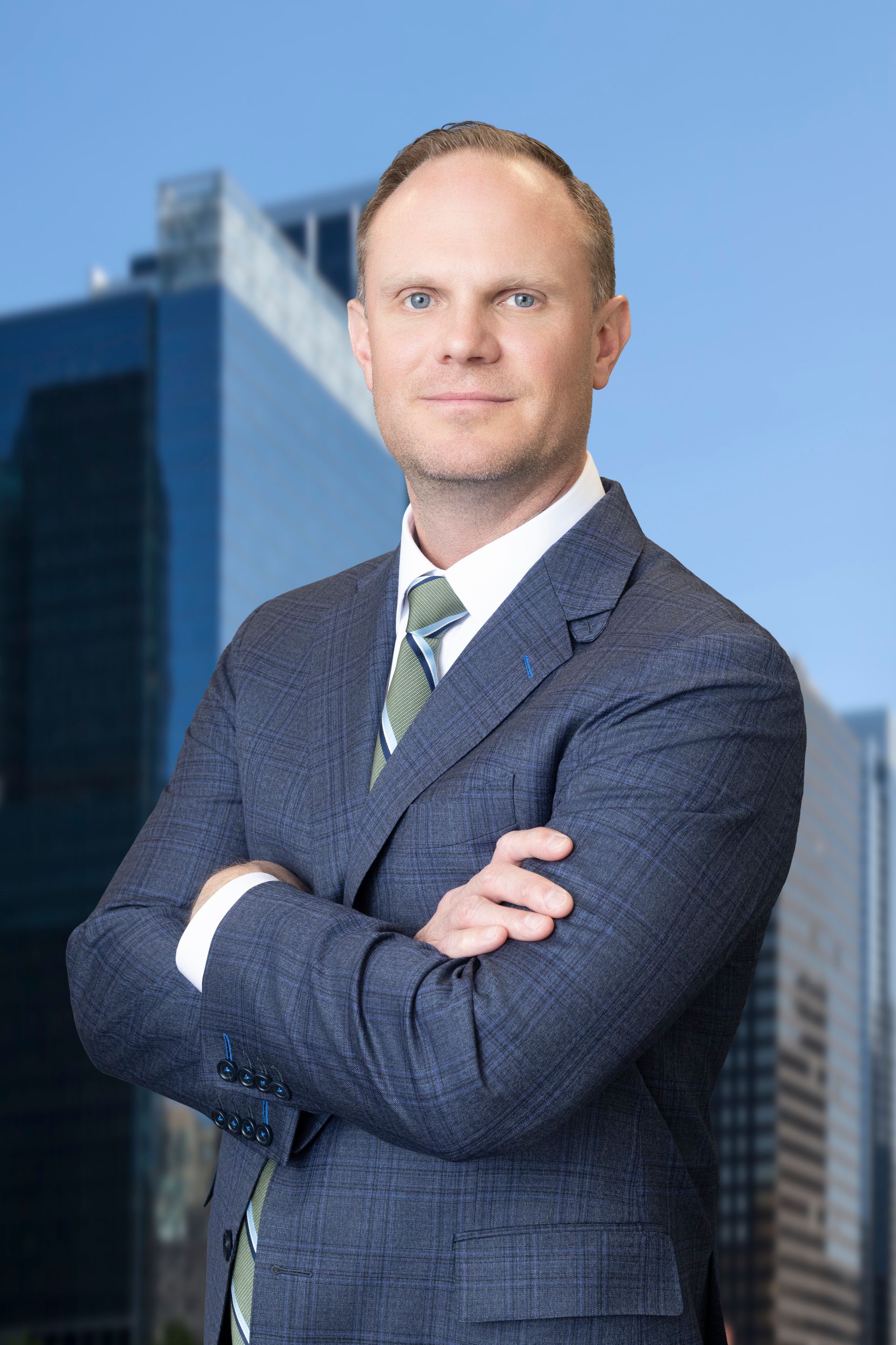 A man in a suit and tie is smiling for the camera