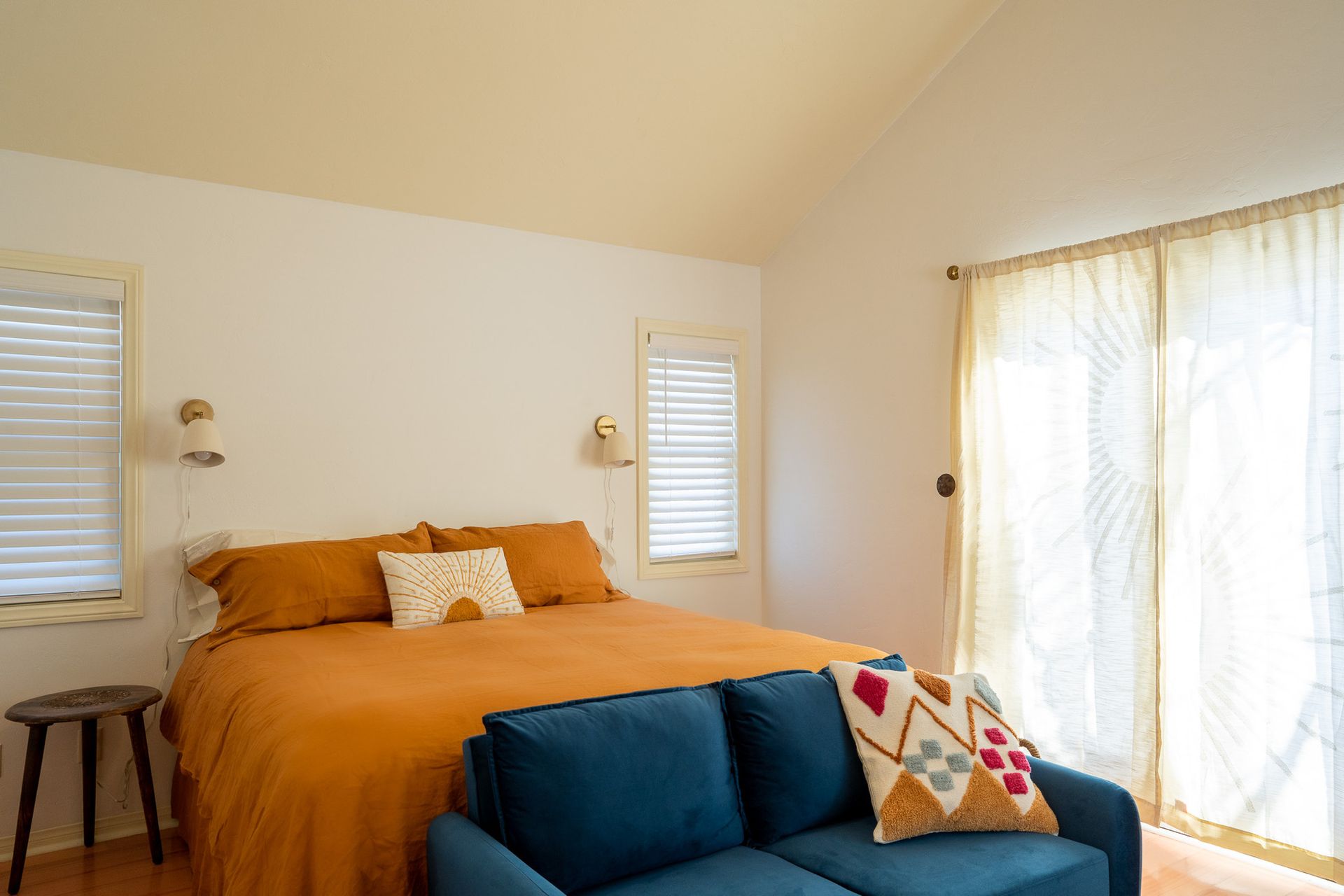 There is a bed and a couch in the room.