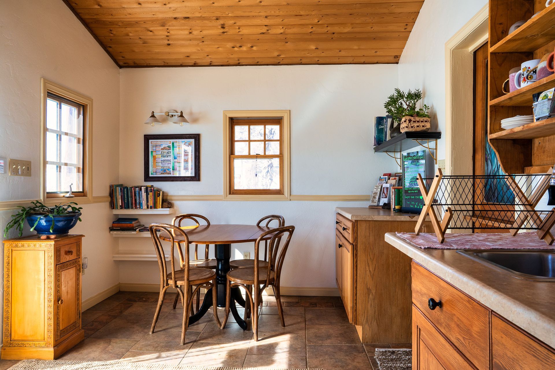 A kitchen with a table and chairs and a sink.
