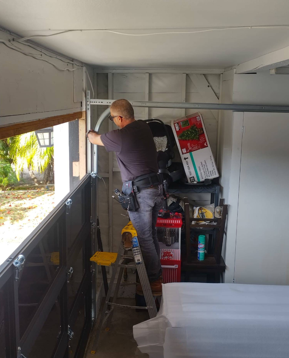 Person working inside a van, adjusting a window near stacked supplies and storage bins.