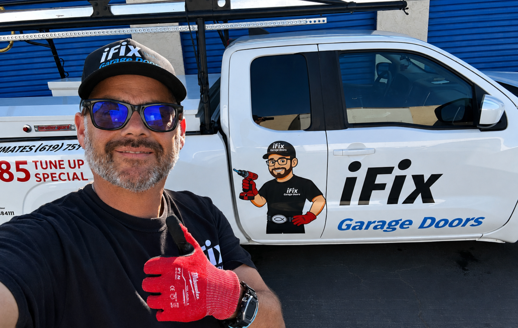 Man in iFix cap and red gloves posing by iFix Garage Doors truck with company logo.