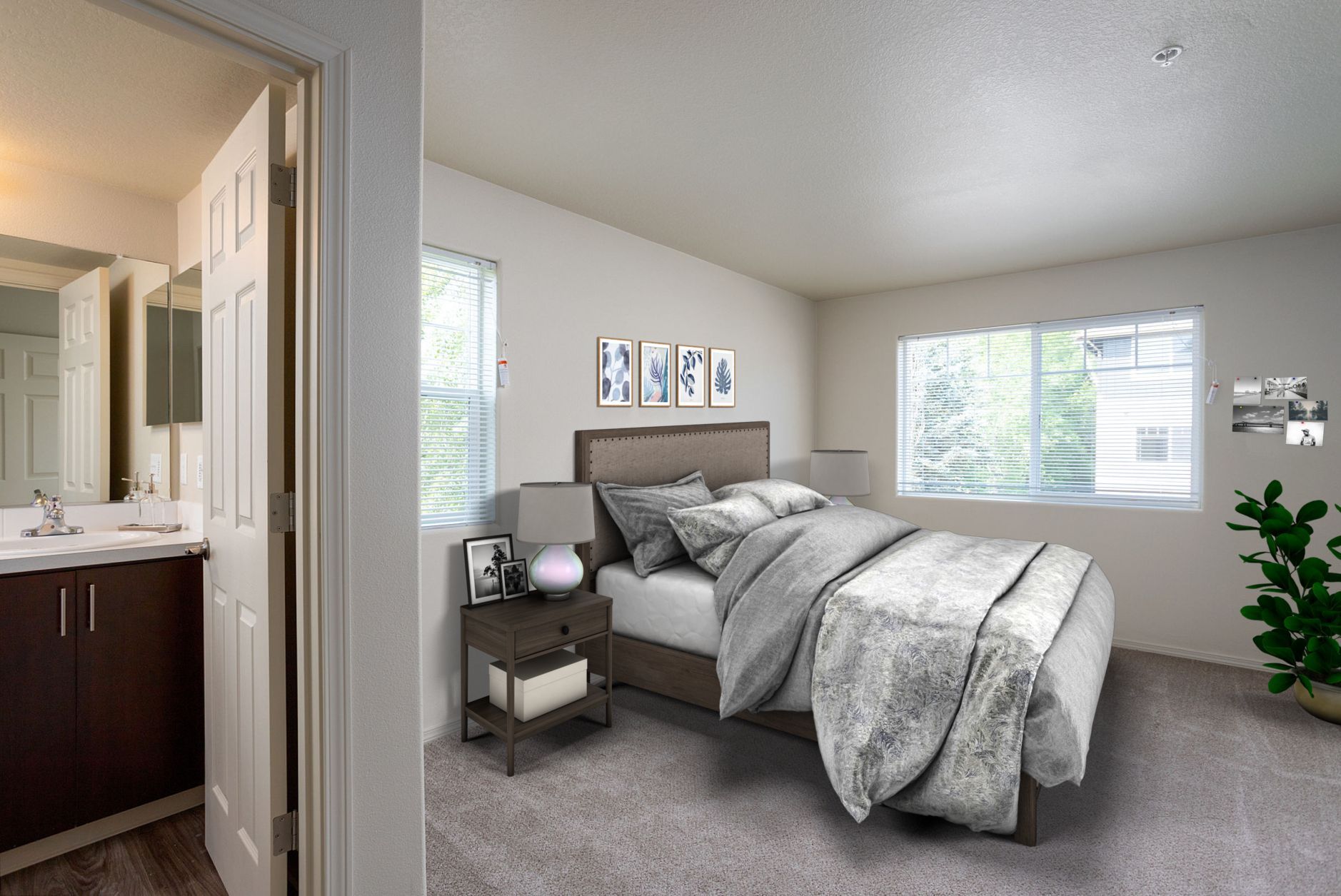 A bedroom with a bed , nightstand , mirror and window.