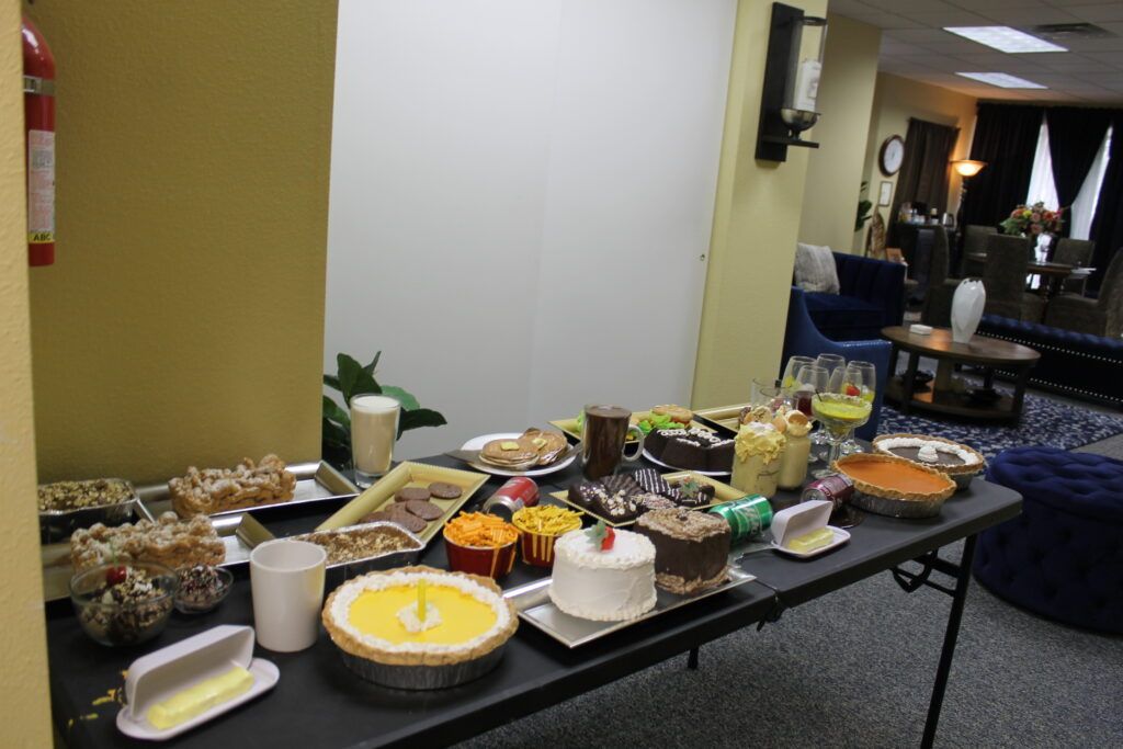 Buffet table with assorted desserts and fruit in a lobby or lounge area