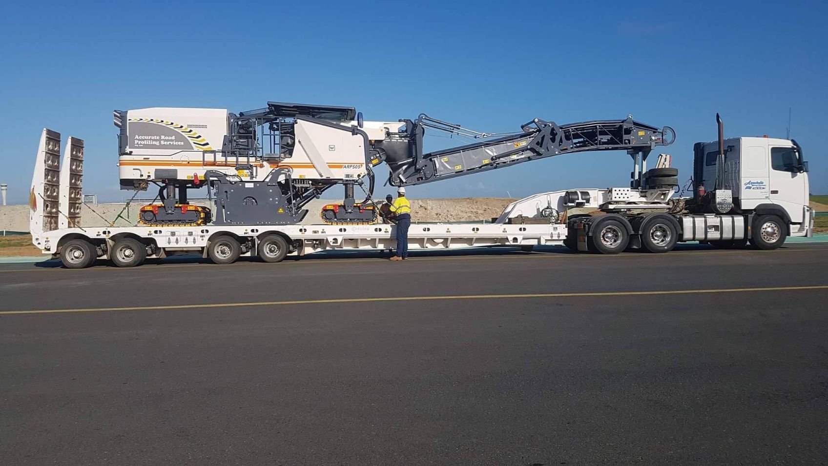 Flatbed Trailer Truck Loaded With Wirtgen Machine — Road Profiling in Caboolture, QLD