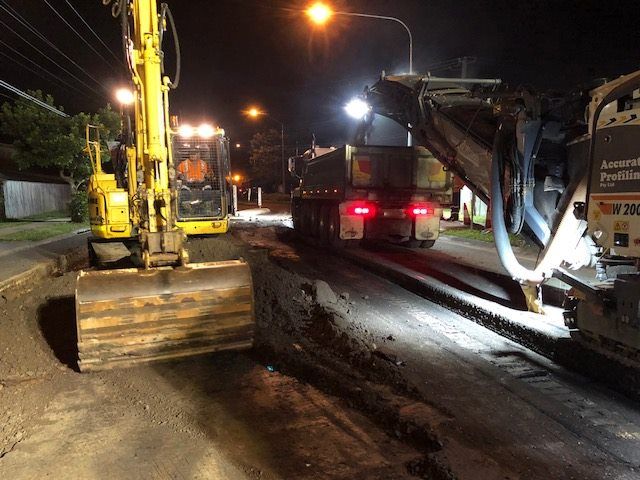 Wirtgen Machine And Excavator On The Road At Night — Road Profiling in Caboolture, QLD
