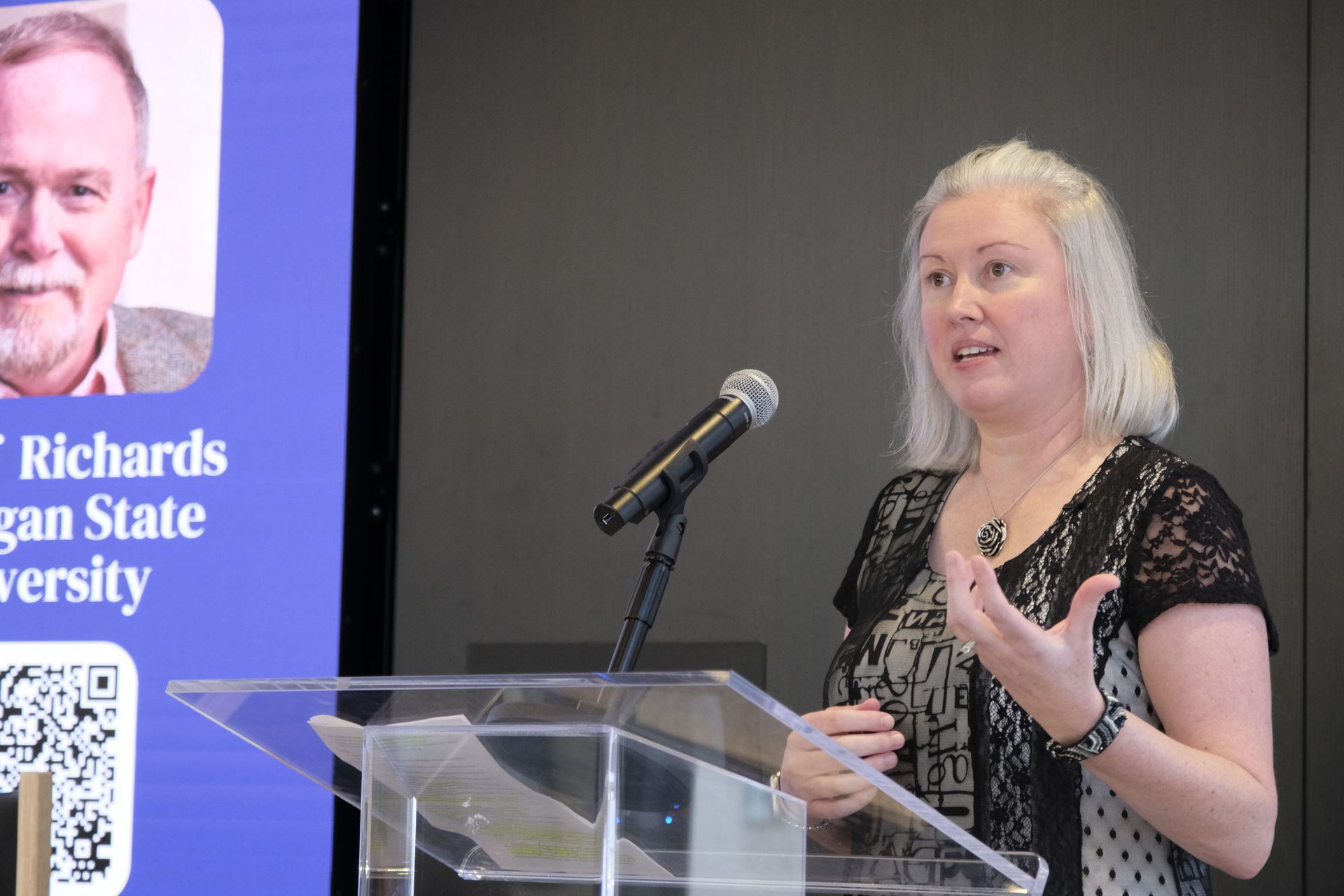 Photo of Dr. Anna McAllister speaking behind the podium 