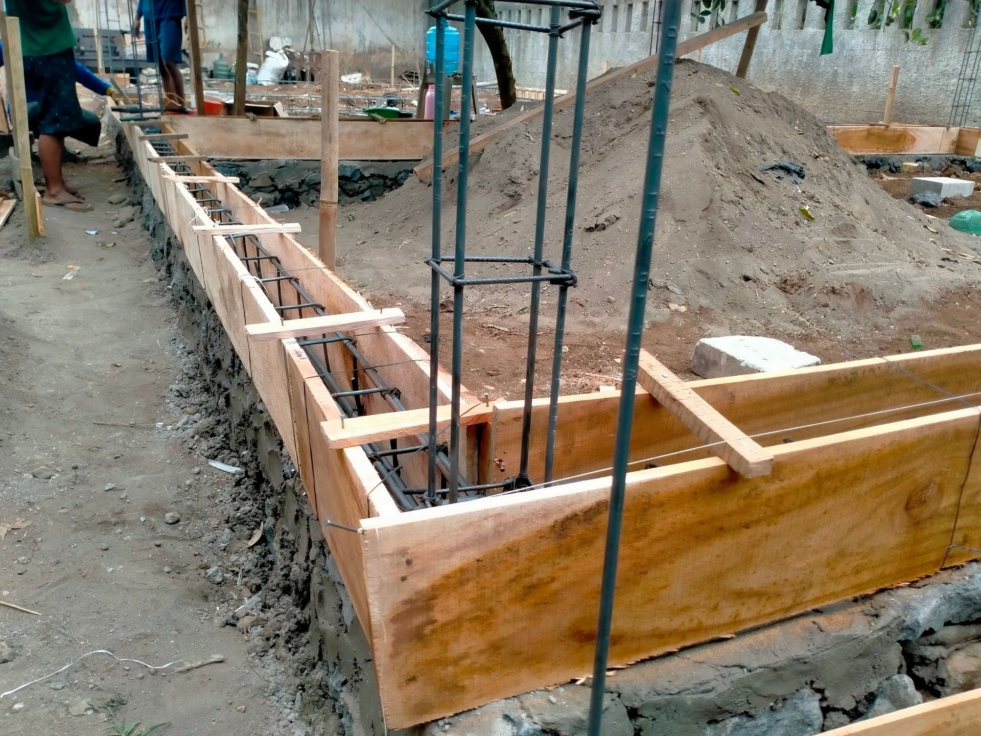Construction site with wooden formwork and rebar for a concrete foundation corner