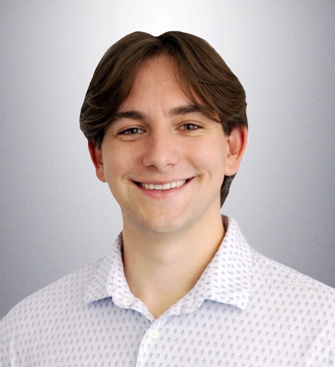 Smiling person in a white patterned shirt against a light gray background